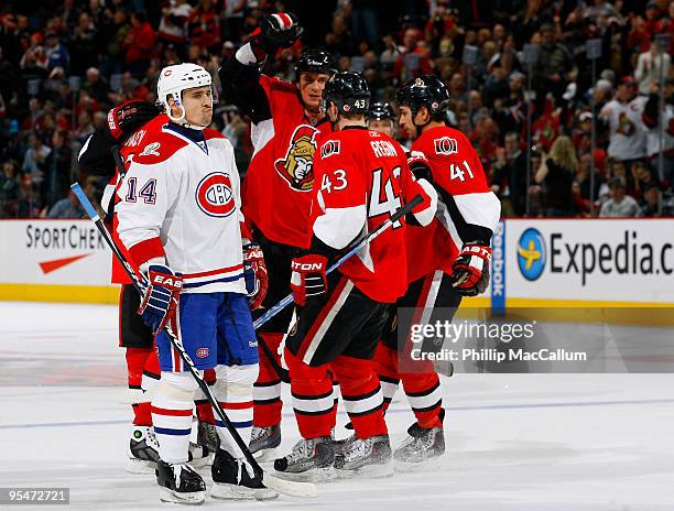 Tomas Plekanec of the Montreal Canadiens looks on dejectedly as the Ottawa Senators celebrate a tying goal in a game at Scotiabank Place on December...