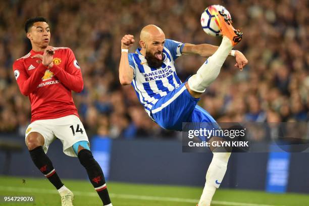 Manchester United's English midfielder Jesse Lingard looks on as Brighton's Spanish defender Bruno Saltor clears the ball during the English Premier...