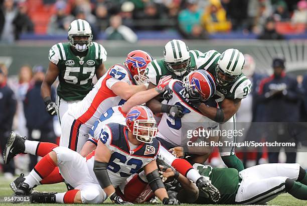 David Harris and Calvin Pace of the New York Jets sack Trent Edwards of the Buffalo Bills at Giants Stadium on October 18, 2009 in East Rutherford,...