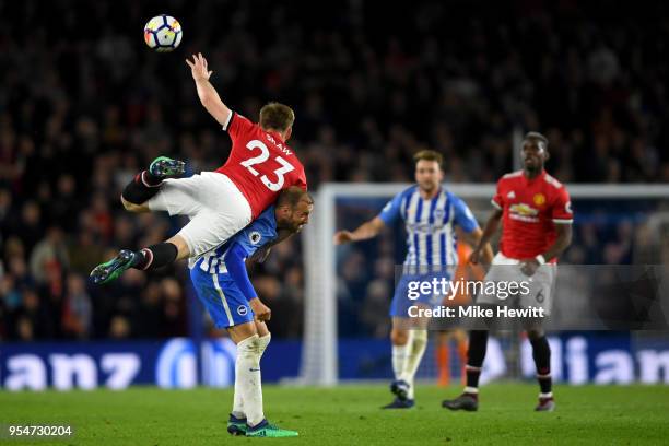 Glenn Murray of Brighton & Hove Albion battles for the ball with Luke Shaw of Manchester United during the Premier League match between Brighton and...