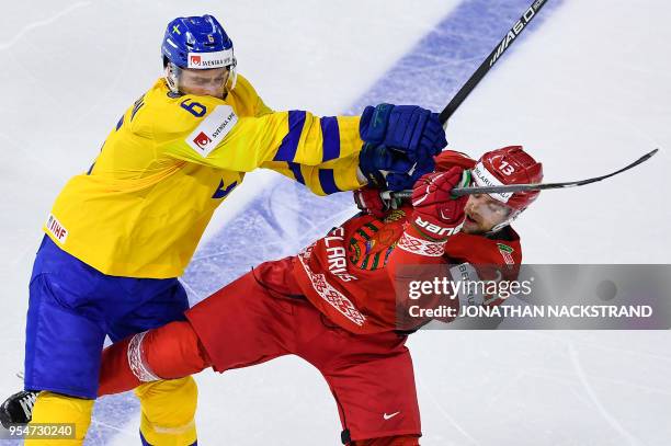 Sweden's Adam Larsson vies with Belarus' Sergei Drozd during the 2018 IIHF Men's Ice Hockey World Championship match between Sweden and Belarus on...