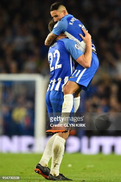 Brighton's French midfielder Anthony Knockaert leaps into the arms of Brighton Irish defender Shane Duffy as they celebrate at the final whistle in...