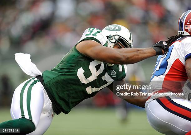 Calvin Pace of the New York Jets tackles Marshawn Lynch of the Buffalo Bills at Giants Stadium on October 18, 2009 in East Rutherford, New Jersey....