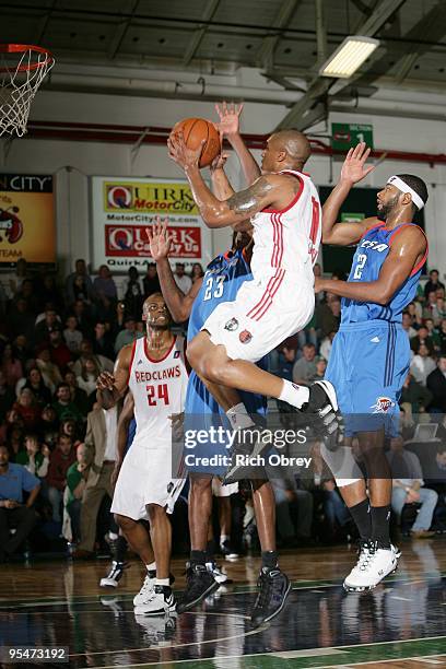 Will Blalock of the Maine Red Claws takes the ball to the basket against Larry Owens and Mustafa Shakur of the Tulsa 66ers during the NBA D-League...