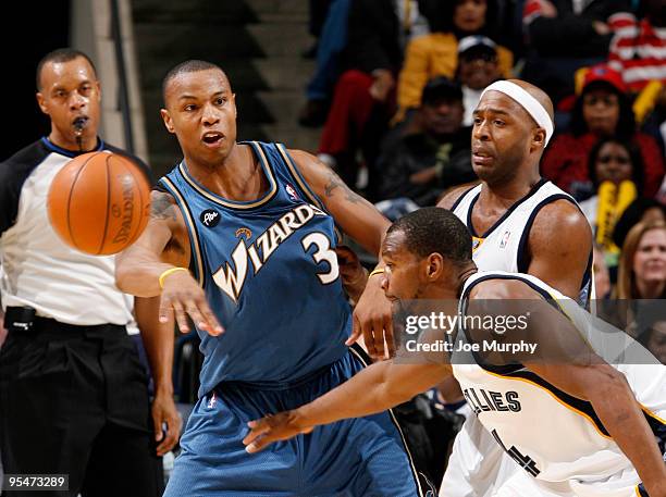 Caron Butler of the Washington Wizards passes the ball against Jamaal Tinsley and Sam Young of the Memphis Grizzlies on December 28, 2009 at...