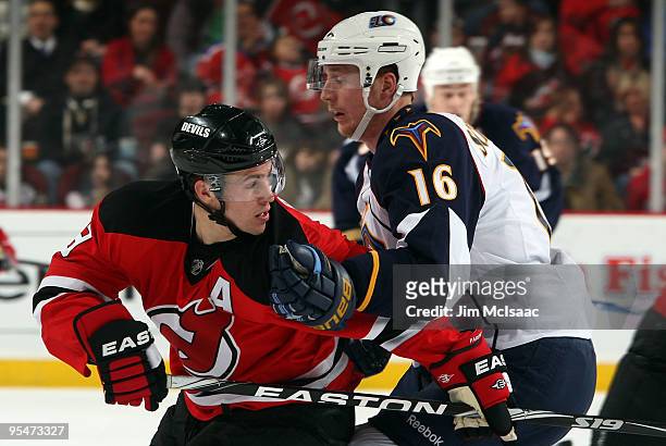 Christoph Schubert of the Atlanta Thrashers defends against Zach Parise of the New Jersey Devils at the Prudential Center on December 28, 2009 in...