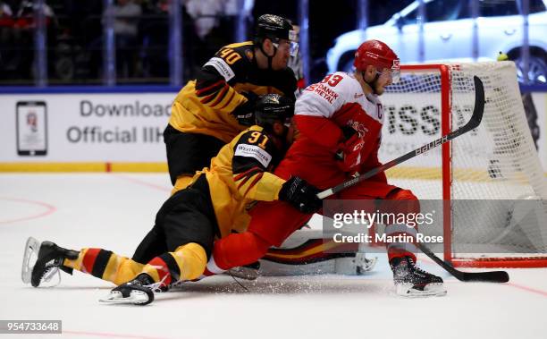 Timo Pielmeier, goaltender of Germany makes a save on Peter Regin of Denmark during the 2018 IIHF Ice Hockey World Championship group stage game...