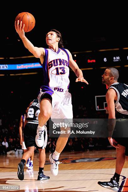 Steve Nash of the Phoenix Suns lays the ball up over Tony Parker of the San Antonio Spurs during the game on December 15, 2009 at US Airways Center...