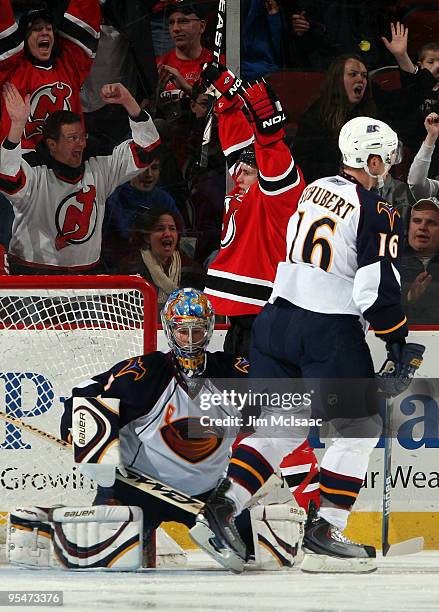 Zach Parise of the New Jersey Devils celebrates his third period goal against Johan Hedberg and Christoph Schubert of the Atlanta Thrashers at the...