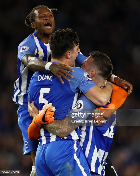 Gaetan Bong of Brighton & Hove Albion celebrates with Lewis Dunk and Shane Duffy at the end of the Premier League match between Brighton and Hove...