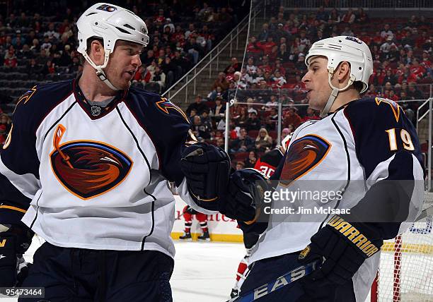 Marty Reasoner of the Atlanta Thrashers celebrates his goal against the New Jersey Devils with teammate Eric Boulton at the Prudential Center on...