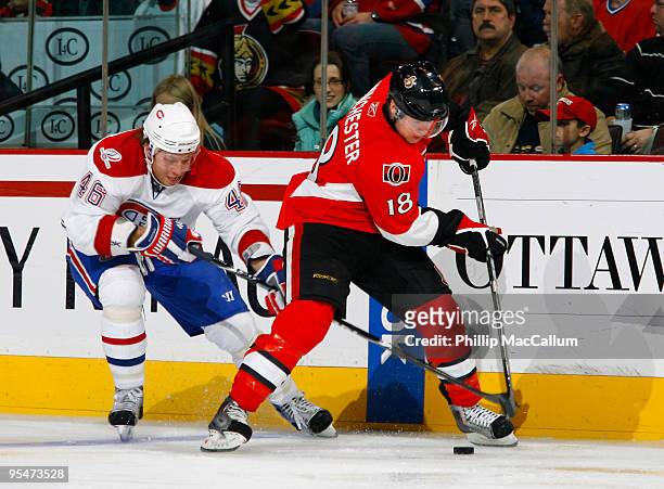 Andrei Kostitsyn of the Montreal Canadiens chases after Jesse Winchester of the Ottawa Senators as he carries the puck back into his zone in a game...