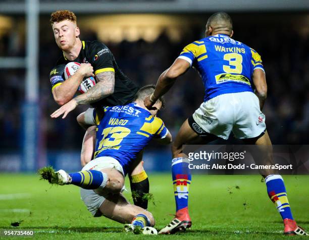 Warrington Wolves' Harvey Livett is tackled by Leeds Rhinos' Stevie Ward during the Betfred Super League Round 14 match between Leeds Rhinos and...