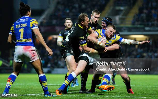 Leeds Rhinos' Brad Singleton is tackled by Warrington Wolves' Ben Westwood and Chris Hill during the Betfred Super League Round 14 match between...