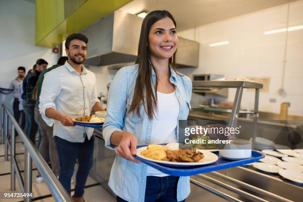 beautiful woman leaving the buffet service with her tray ready to eat lunch - lunch buffet stock pictures, royalty-free photos & images
