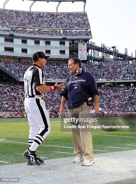 Head Coach Bill Belichick of the New England Patriots looks on with referee Jim Mello against the Baltimore Ravens at Gillette Stadium on October 4,...