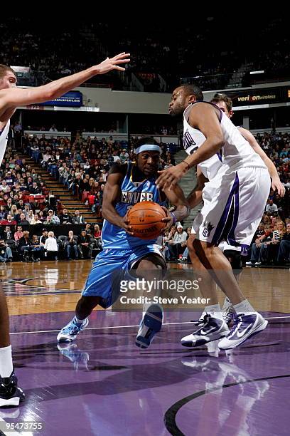 Ty Lawson of the Denver Nuggets drives to the basket against Kenny Thomas of the Sacramento Kings on December 28, 2009 at ARCO Arena in Sacramento,...