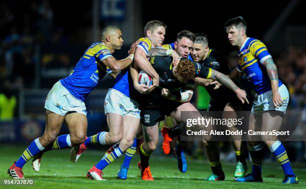 Leeds Rhinos' Tom Briscoe, Matt Parcell and Richie Myler try to shepherd Warrington Wolves' Harvey Livett into touch during the Betfred Super League...