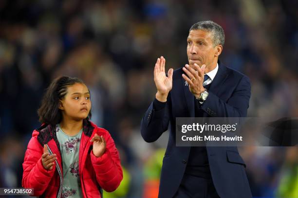 Chris Hughton, manager of Brighton & Hove Albion celebrates on the pitch after the Premier League match between Brighton and Hove Albion and...