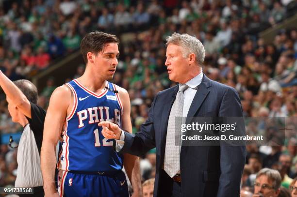 Head Coach Brett Brown of the Philadelphia 76ers speaks with T.J. McConnell of the Philadelphia 76ers during the game against the Boston Celtics...