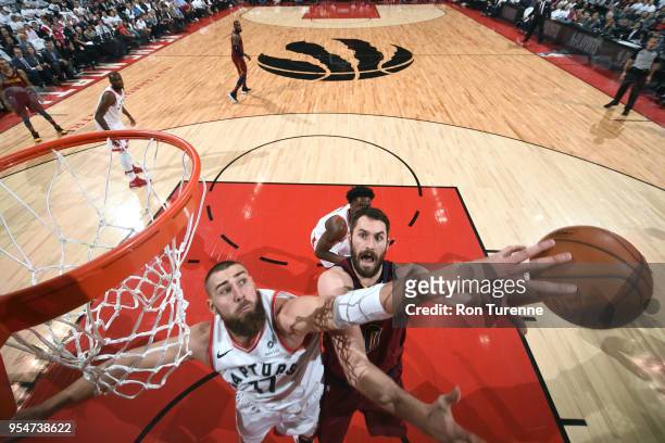 Jonas Valanciunas of the Toronto Raptors blocks as Kevin Love of the Cleveland Cavaliers goes to the basket in Game Two of Round Two of the 2018 NBA...