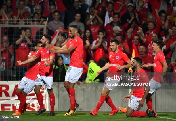 Ajaccio's midfielder Youssouf M'Changama with his teammates reacts after scoring a goal during the French L2 football match between Nimes and...