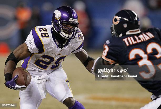 Adrian Peterson of the Minnesota Vikings runs the ball against Charles Tillman of the Chicago Bears in the third quarter at Soldier Field on December...