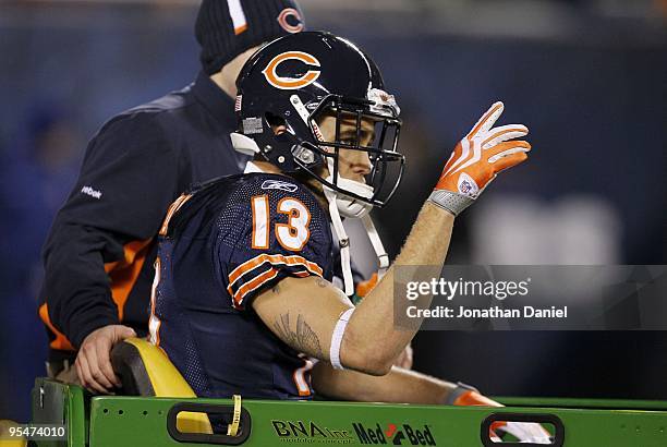 Kick returner Johnny Knox of the Chicago Bears waves to the crowd after he is carted off the field after being injured on a kick return in the third...