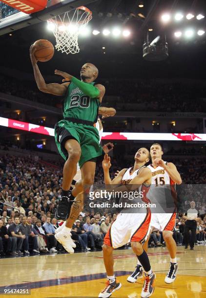 Ray Allen of the Boston Celtics shoots over Stephen Curry of the Golden State Warriors during an NBA game at Oracle Arena on December 28, 2009 in...