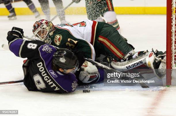 Drew Doughty of the Los Angeles Kings slides into goaltender Niklas Backstrom of the Minnesota Wild in the second period during the NHL game at the...