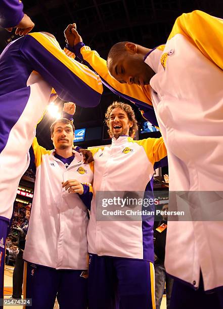 Adam Morrison, Pau Gasol and Kobe Bryant of the Los Angeles Lakers huddle up before the NBA game against the Phoenix Suns at US Airways Center on...
