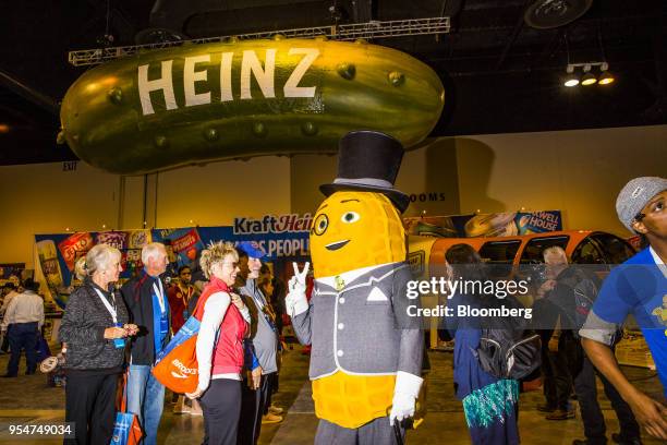 Person dressed as the Kraft Heinz Co. Mr. Peanut mascot gestures to attendees during a shareholders shopping day ahead of the Berkshire Hathaway...