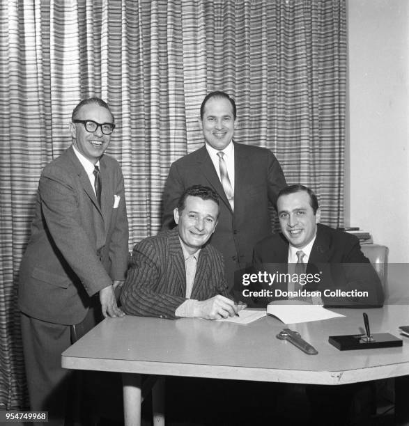 Singer Lou Monte signs with Joe Reisman, Morris Levy, George Brown for Roulette Records on March 30, 1960 in New York.
