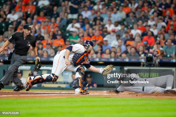 New York Yankees second baseman Neil Walker goes around Houston Astros catcher Brian McCann for the scored in the second inning during an MLB...