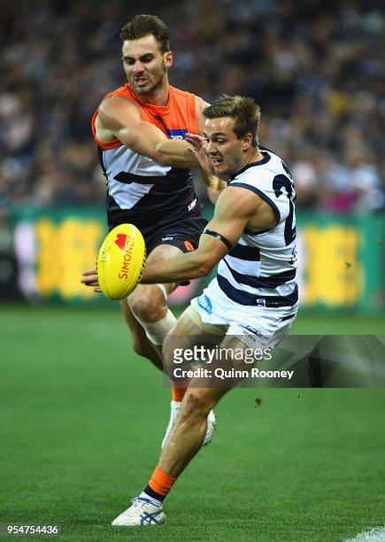 Jeremy Finlayson of the Giants and Cory Gregson of the Cats compete for the ball during the round seven AFL match between the Geelong Cats and the...