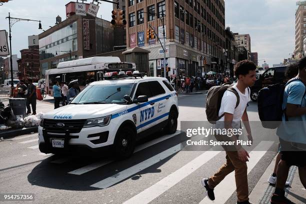 People walk through an area of the South Bronx with a high heroin addiction rate on May 4, 2018 in New York City. In an attempt to reverse the number...