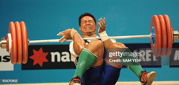 Niusila Opeloge of Samoa loses control of an attempted lift during the men's 105kg weightlifting event at the Melbourne Exhibition Centre during the...