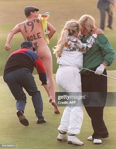 Streaker runs onto the 18th green as John Daly and his wife Paulette celebrate after Daly beat Costantino Rocca of Italy in a play-off to take the...