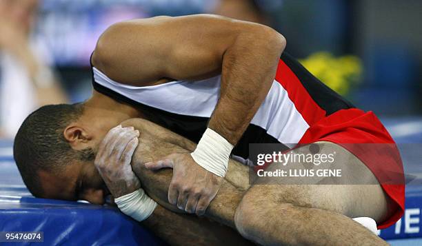 Tamer Ragbat of Egypt holds his knee after his vault during the men's qualifying round of the 40th World Artistic Gymnastics Championships 04...