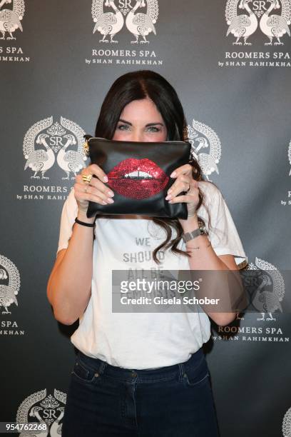 Alexandra Polzin with lips painted on a clutch during the Grand Opening of Roomers Spa by Shan Rahimkhan on May 4, 2018 in Munich, Germany.