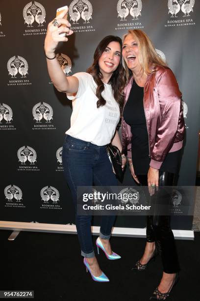 Alexandra Polzin, Nicole Belstler-Boettcher take a selfie during the Grand Opening of Roomers Spa by Shan Rahimkhan on May 4, 2018 in Munich, Germany.