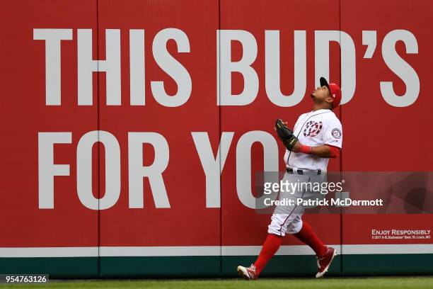 Moises Sierra of the Washington Nationals watches a fan in the stands catch David Peralta of the Arizona Diamondbacks solo home run in the fourth...