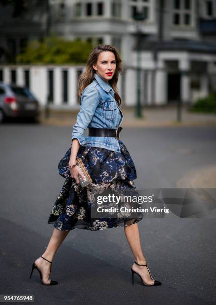 Alexandra Lapp wearing tiered corded lace and brocade in a mix of black, midnight-blue and gold by Marchesa Notte, blue trucker denim jacket by...