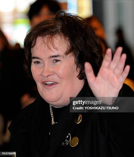 Scottish singer Susan Boyle waves upon her arrival at the Narita International Airport in Narita city in Chiba prefecture on December 29, 2009....