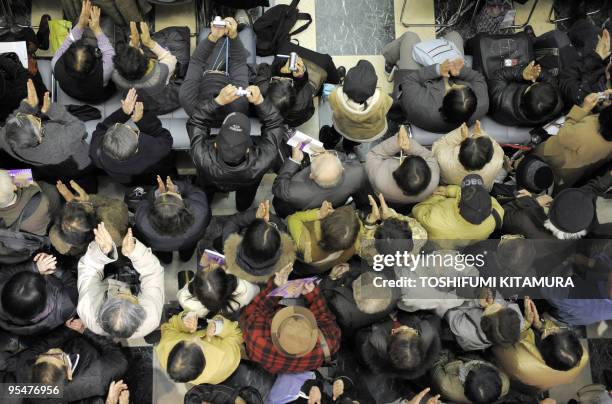 Year-end shoppers applaud to cheer a 223-member chorus group and four soloists as they perform Ludwig Van Beethoven's Symphony No.9 "Choral" during...