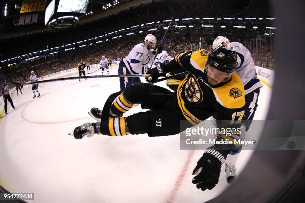 Cedric Paquette of the Tampa Bay Lightning checks Ryan Donato of the Boston Bruins into the boards during the third period of Game Four of the...