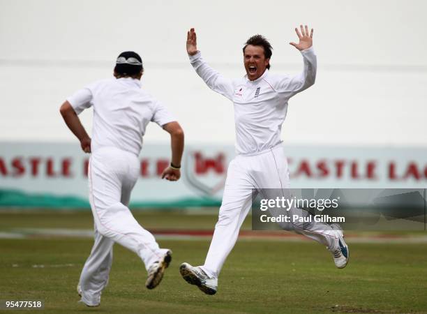 Graeme Swann of England celebrates with Ian Bell after taking the wicket of Ashwell Prince of South Africa for 16 runs when he was caught out by Ian...