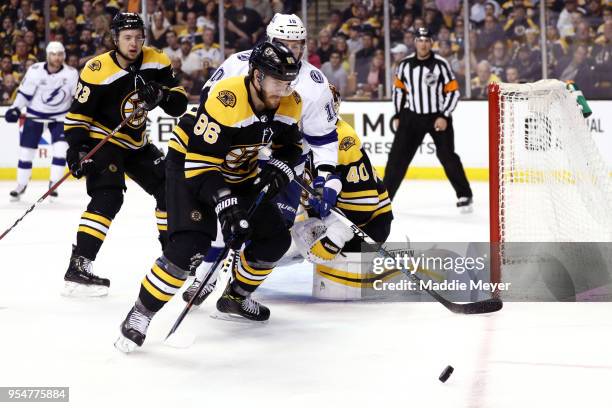 Kevan Miller of the Boston Bruins and J.T. Miller of the Tampa Bay Lightning battle for control of the puck during the second period of Game Four of...