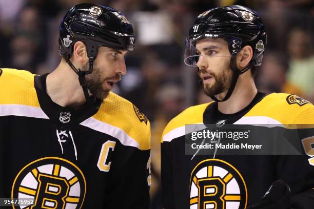 Zdeno Chara of the Boston Bruins talks with Adam McQuaid during the second period of Game Four of the Eastern Conference Second Round against the...