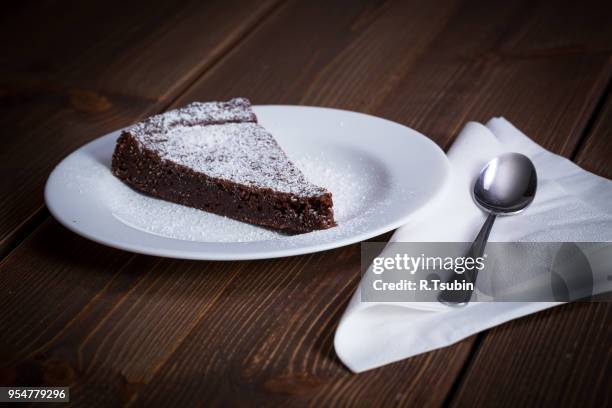 chocolate cake slice on white dish and wooden background - butter tart stock pictures, royalty-free photos & images